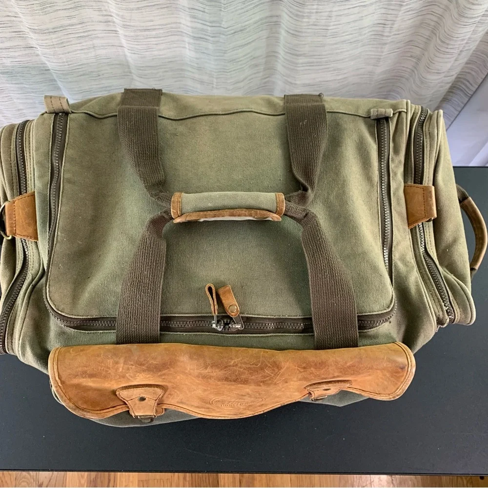 High Sierra Green canvas and Brown leather Duffel Bag.